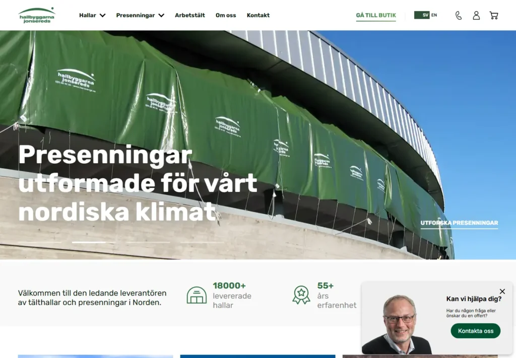 Green tarps covering large containers at a commercial facility